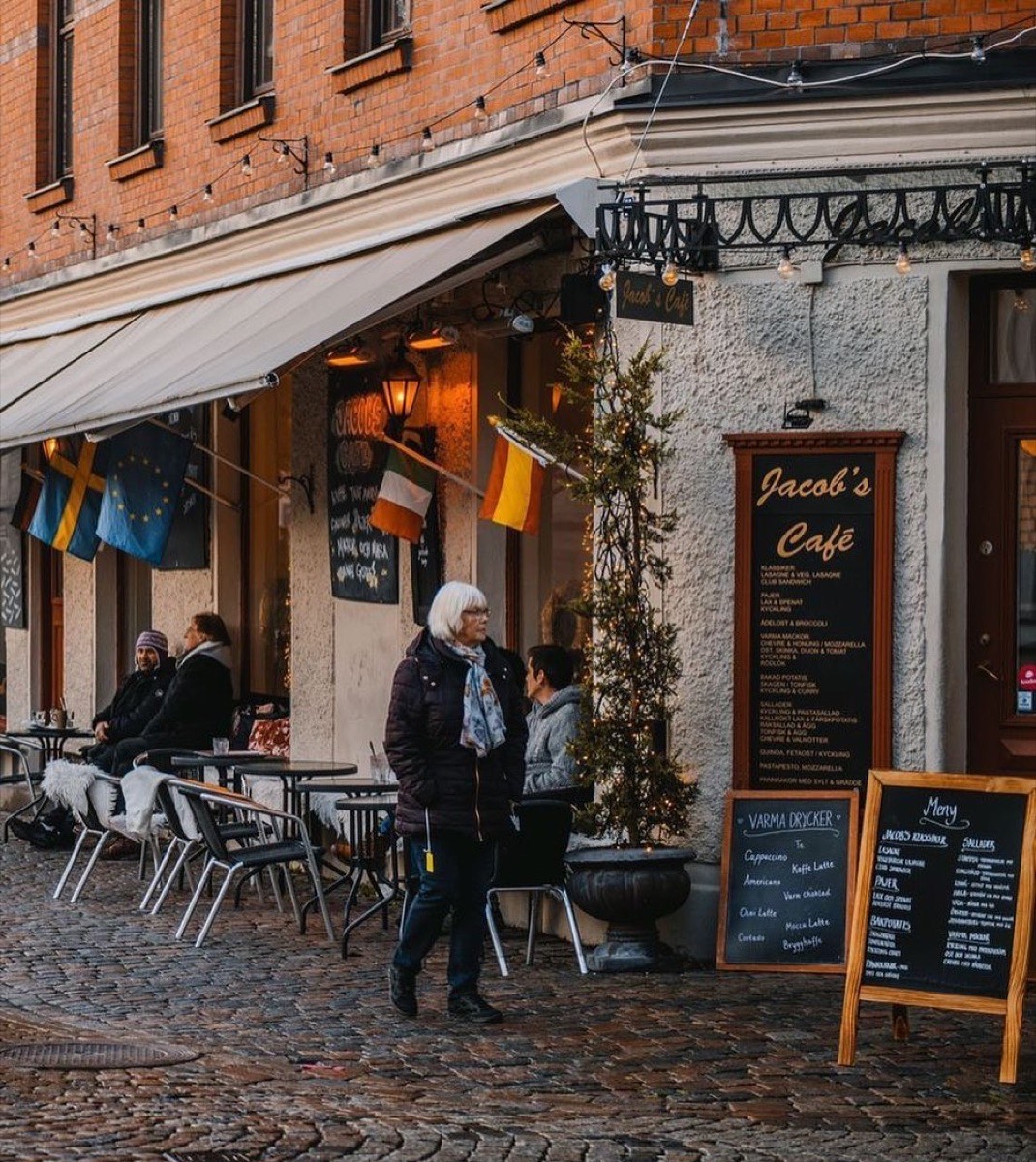 Kaféet en vinterdag med ljusslingor, fällar på stolarna och gäster ute